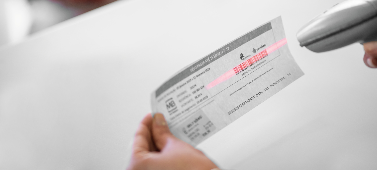 Pessoa a picotar código de barras para efetuar um pagamento.